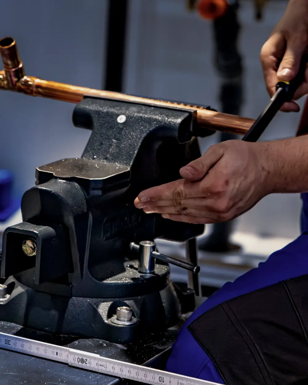 Copper pipe being bent in a vise before a repipe